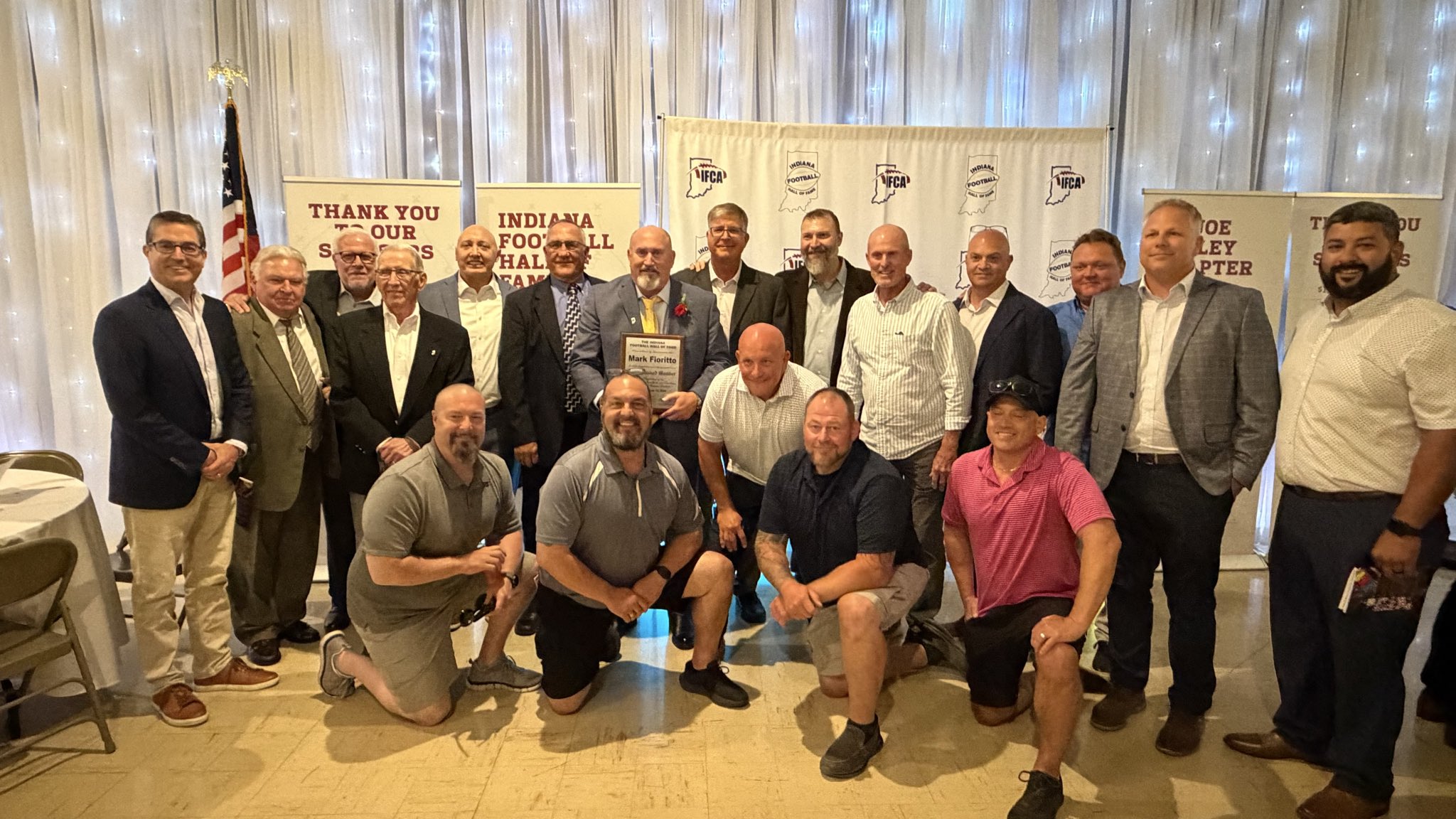 Photo of Mark Fioritto with his former players and coaches at his hall of fame induction ceremony