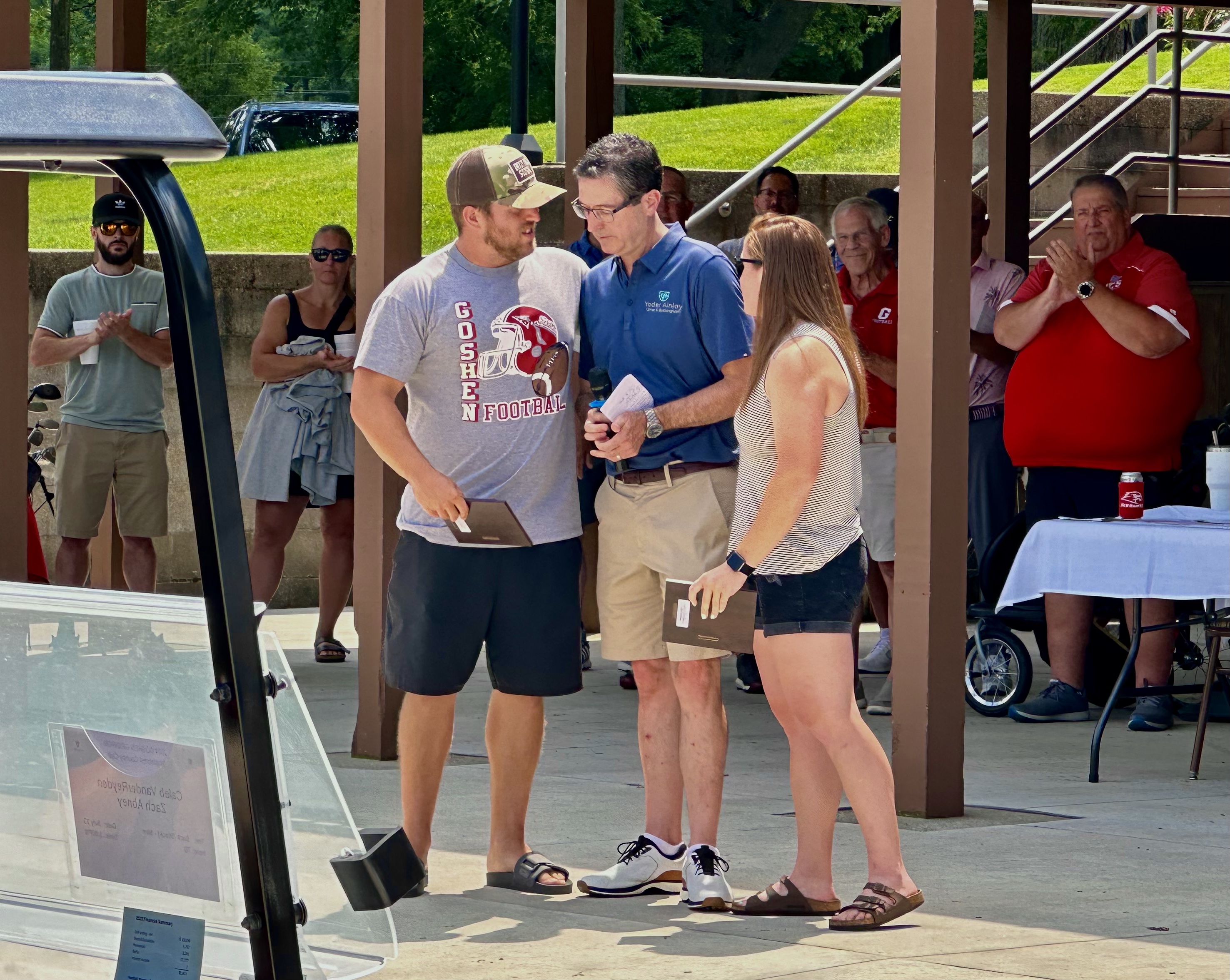 Gridiron Club President David Swihart presents the Keith and Janet Swihart Memorial Award to Nathan and Aimee Swihart in honor of their Dad Steve.